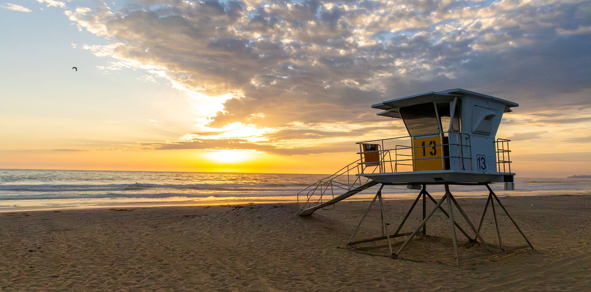 Sunset over San Diego beach with lifeguard tower